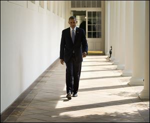 President Obama walks along the West Wing Colonnade toward the Oval Office of the White House in Washington today ahead of his daily briefing. Obama will deliver a speech on Syria from the East Room in an address to the nation this evening.