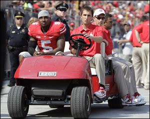 Ohio State quarterback Braxton Miller, left, is carted off the field after being injured during the first quarter against San Diego State.