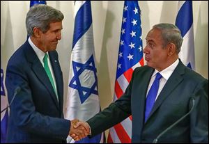 John Kerry, left, shakes hands with Israel’s Prime Minister Benjamin Netanyahu Sunday in Jerusalem after speak-ing to the press.