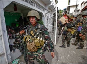 Soldiers arrive in Zamboanga in the south Philippines on Sunday with supplies for the offensive against Muslim insurgents. The fighting began a week ago.