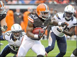 Cleveland Browns running back Trent Richardson (33) breaks a tackle by San Diego Chargers safety Eric Weddle (32) on a 26-yard touchdown run in the first quarter of an NFL football game last year.