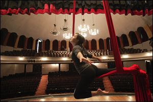 Instructor Erin Garber-Pearson of Toledo shows a flying technique during a beginner aerial silks class at the Birds Eye View Circus Space at the Collingwood Arts Center.