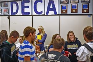 Becky Byrd, right, jokes with one of her senior students  during DECA class at Perrysburg High School. 
