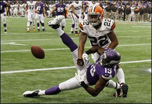 Cleveland Browns cornerback Buster Skrine (22) breaks up a pass in the end zone intended for Minnesota Vikings wide receiver Greg Jennings (15) during the first half of an NFL football game Sunday, Sept. 22, 2013, in Minneapolis. (AP Photo/Ann Heisenfelt)