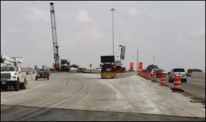 Traffic is kept to the side as work takes place on the ramp bridge from eastbound I-475 to northbound I-75 in Toledo.