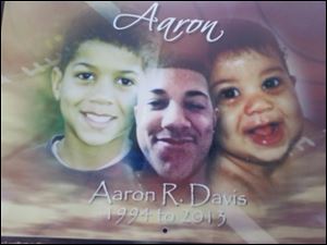 Sign for Aaron Davis , who was killed in a car crash on the Anthony Wayne Trail in February 2013. 