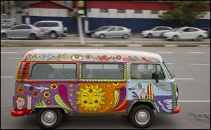 Advertising executive Marcelo Serpa drives his Volkswagen van, emblazoned with a ‘rolling mural’ that he painted, through the streets of Sao Paulo.