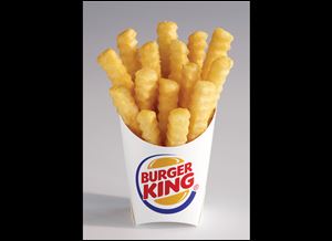 Burger King shows the new french fry that the company says has 20 percent fewer calories than its regular fries. The Satisfries will cost about 30 cents more than its regular fries.