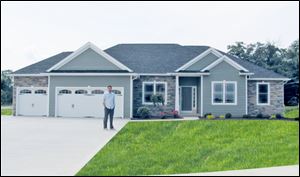 Builder Josh Doyle stands before the model home for Whitehouse Valley. 