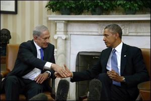 President Barack Obama shakes hands with Israeli Prime Minister Benjamin Netanyahu during their meeting today in the Oval Office of the White House in Washington.