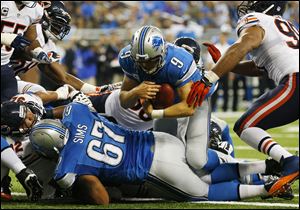 Detroit Lions quarterback Matthew Stafford (9) falls over the goal line for a touchdown after recovering his own fumble.