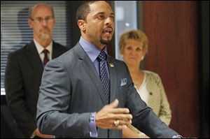 TPS interim Superintendent Romules Durant wears the district's monogram on his shirt cuff.