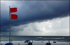Red flags warn swimmers to stay out of the Gulf of Mexico as a squall from Tropical Storm Karen moves offshore at Gulf Shores, Ala.