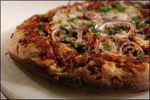 Barbecue chicken pizza can be incorporated into a rotisserie chicken dinner.