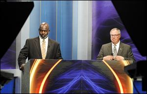 Toledo mayoral candidates Mayor Mike Bell, left, and D. Michael Collins prepare for their first televised debate. Monday's event was at WNWO-TV, Channel 24.
