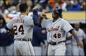 Detroit Tigers Miguel Cabrera (24) celebrates with teammate Torii Hunter (48) after he scored a two run home run that also scored Hunter in the fourth inning of Game 5.