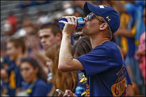 UT senior Jonathon Hilvers drinks beer during the Rockets’ football game last weekend at the Glass Bowl. This is the first year UT has allowed the sale of alcohol at sporting events. 