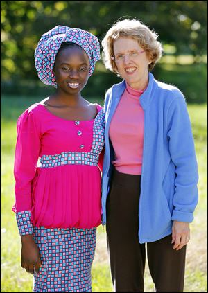 Esther Ibrahim, 15, a Nigerian exchange student at Bedford High School, pauses with her host ‘mom,’ Teresa Arnold of Lambertville. 