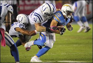 San Diego Chargers running back Danny Woodhead (39) powers upfield as Indianapolis Colts inside linebacker Pat Angerer (51) and defensive back Josh Gordy (27) try to haul him down during the second half.