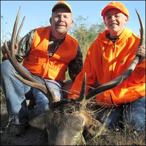 Mark Armbruster of Wood County and his son, Ben, 12, pose with a 5 by 5 bull elk Ben harvested while hunting in southeastern Kentucky last week.