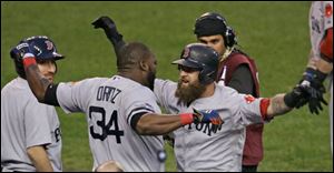 Boston Red Sox's David Ortiz celebrates with Mike Napoli after Napoli hits a home run in the seventh inning.