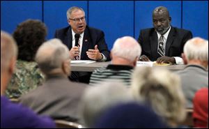 Mayoral candidates D. Michael Collins, left, and Mayor Mike Bell attend the South Toledo Neighborhood Alliance's mayoral candidate forum at Burroughs School.