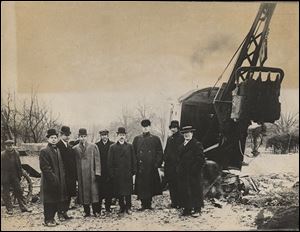 Construction of Scott High School began on Jan. 3, 1911. In front of a steam shovel are representatives of the Toledo school board and contractors.