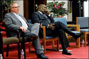 Challenger D. Michael Collins and incumbent Mayor Mike Bell listen during the mayoral candidate debate at the South Toledo Community Center on Broadway.