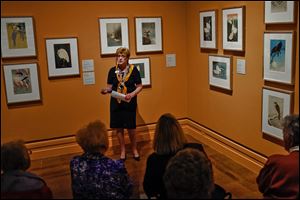 Docent Mary Galvin gives a tour of the exhibit of early modern Japanese prints. The new 135 LED lights are enhancing the experience.