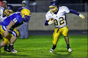 Toledo Christian's Caleb Wotring, right, runs past Northwood's Myles Habel chases on Friday. The junior finished with 133 yards.
