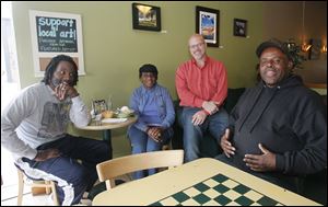 Pastor Daniel Hughes, left, his mother, Annie Hughes, Tim VonDrell, and Jimmy Wilkerson talk politics. Mr. Hughes, Ms. Hughes, and Mr. Wilkerson said some in Congress disrespect Mr. Obama because of his color.