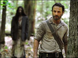 Andrew Lincoln portrays Rick Grimes in a scene from the season four premiere of 