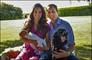 The Duke and Duchess of Cambridge pose in August  with their son in Bucklebury, England, and with  Tilly, left, a Middleton pet, and their cocker spaniel, Lupo.