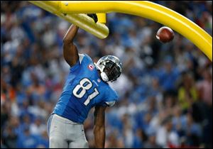 Detroit Lions wide receiver Calvin Johnson (81) celebrates his 50-yard touchdown reception against the Cincinnati Bengals in the fourth quarter of an NFL football game. 'Megatron' is one of the most exciting players in America's favorite billion-dollar football industry.