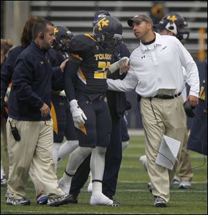UT's David Fluellen is escorted off the field by head coach Matt Campbell during 2nd half of the Rockets' win against Navy, Saturday, Oct. 19, 2013. He was injured and left the game.