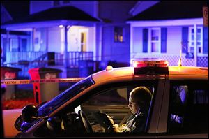Police on the scene where a Ms. Wells was shot at 658 Spring St. in North Toledo Wednesday.