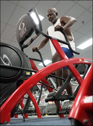 Mayor Mike Bell exercises on an elliptical machine at Super Fitness on North Reynolds Road. He works out four days a week.