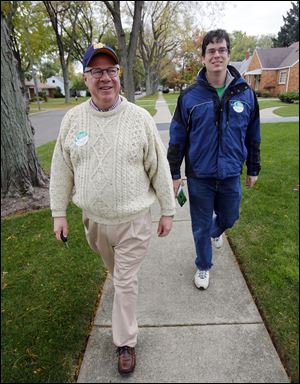 Toledo Councilman D. Michael Collins, a candidate for mayor, goes door to door with Steve Leggett. 'The younger members of my campaign are challenged to keep up with me day-to-day,' Mr. Collins says.