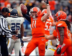 Bowling Green QB Matt Johnson (11) celebrates scoring a touchdown against Toledo during the second quarter.