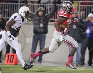 Ohio State running back Carlos Hyde, right, outruns Penn State safety Adrian Amos on his way to scoring a touchdown during the second quarter. Hyde rushed for 147 yards and two touchdowns. Ohio State is now 9-0.