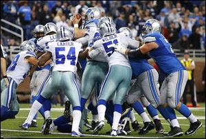 Lions quarterback Matthew Stafford scores on a 1-yard touchdown run against the Dallas Cowboys with only 12 seconds left Sunday in Detroit.