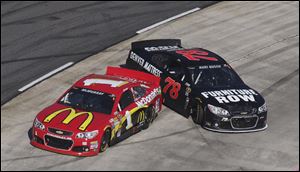 Sprint Cup Series driver Jamie McMurray, left, and Kurt Busch spin out during the NASCAR Sprint Cup  race in Martinsville, Va.