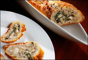 Spinach and artichoke-stuffed baguette slices.