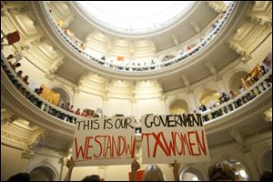 Abortion rights supporters rally on the floor of the State Capitol rotunda in Austin, Texas, in this July file photo.