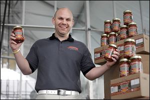 Donald Hill holds jars of his Brickyard Sloppy Joe sauce, sold at 26 retailers in northwest Ohio.