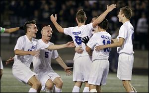 Anthony Wayne’s Grant Oliver, center, celebrates with his teammates after he scored the go-ahead goal against St. John’s.