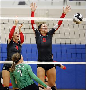 Central Catholic’s Sierra Sedlak (5) and Dani Tschantz (4) defend against  Celina’s Michaela Wenning (7) in a D-II regional semifinal volleyball game. Central won in three games.