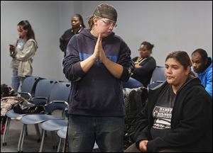 Shelbie Bailey, left, and her fiancee, Ilana Kahan, wait to file paperwork for food stamps at the Lucas County Job and Family Services Building in West Toledo on Friday. Ms. Bailey said her monthly benefit was decreasing from $200 to $189. She has been jobless over a year despite seeking work, she said. Ms. Kahan is three months pregnant.  