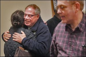Mayoral candidate D. Michael Collins hugs attorney Christine Reardon after addressing about 25 members of various local unions at the Toledo Police Patrolman’s Association.