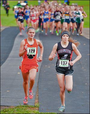 Brittany Atkinson, left, of Liberty Center looks to pass Sarah Kanney of Coldwater at the Division III state meet. Atkinson won in 18 minutes, 31.45 seconds.